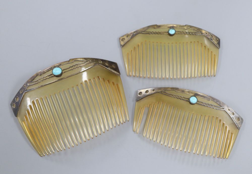 An early 20th century Art Nouveau graduated set of three sterling and turquoise cabochon set horn hair combs